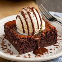 Warm chocolate brownie served with vanilla ice cream - decadent dessert at Coffee Koffein