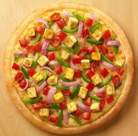 Paneer tikka pizza with Indian spiced cottage cheese and vegetables - fusion cuisine at Coffee Koffein