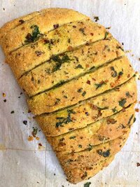 Stuffed garlic bread with cheese and herbs - warm appetizer at Coffee Koffein